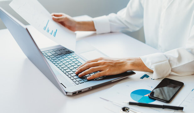 Cropped image of Asian businesswoman using laptop to working