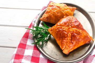 Fresh homemade pastries are on an iron tray