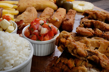 Cuban filet. Made with breaded Steak, breaded ham and cheese, French Fries, Vinaigrette, white rice, pineapple and Fig. Close-up photo of Latin cuisine and tropical climate.
