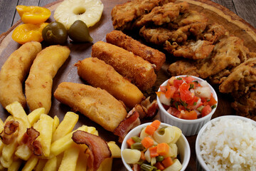 Cuban filet. Made with breaded Steak, cheese, breaded ham and banana, Vinaigrette, white rice, pineapple and Fig. Typical Brazilian dish. Tropical cuisine.