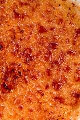 Creme brulee with sugar crust close up. Macro photo
