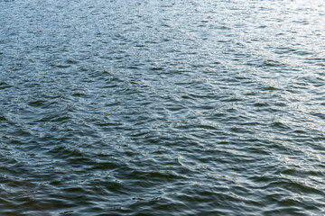 Blue water surface, river background.