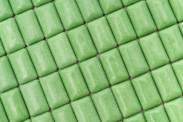 Green mint chewing gum tablets aligned. Top view. Close-up.