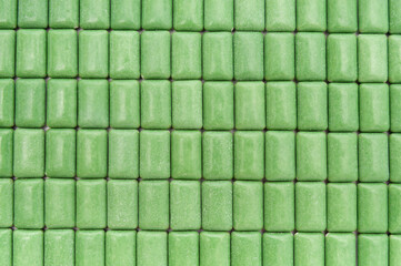 Green mint chewing gum tablets aligned. Top view. Close-up. Horizontal shot.