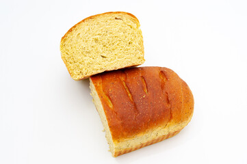 Delicious homemade spiced bread cut in half isolated on white background. Horizontal shot. Copy space.