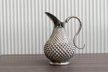 metal vintage jug with embossed pattern