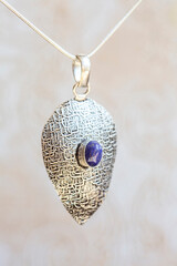 Silver metal pendant in natural shape with mineral stone decoration