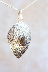 Silver metal pendant in natural shape with mineral stone decoration