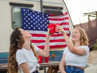 Dos mujeres guapas y jóvenes disfrutando de Día de la Independencia de los Estados Unidos
