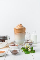 Refreshing coffee drink with milk and ice on a white background.