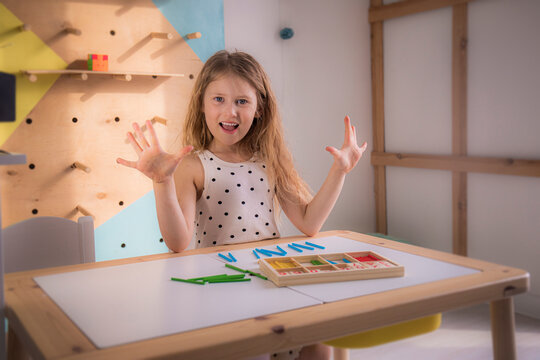 Caucasian girl learning to count at home in the classroom, preschool education for children, mathematics for kids, lessons for elementary school