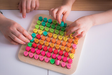 Little caucasian girl studying numbers and math in the classroom, stylish interior for home education, preschool child education, home schooling