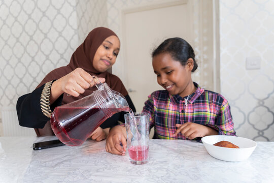 Black Muslim mother spending time with daughter