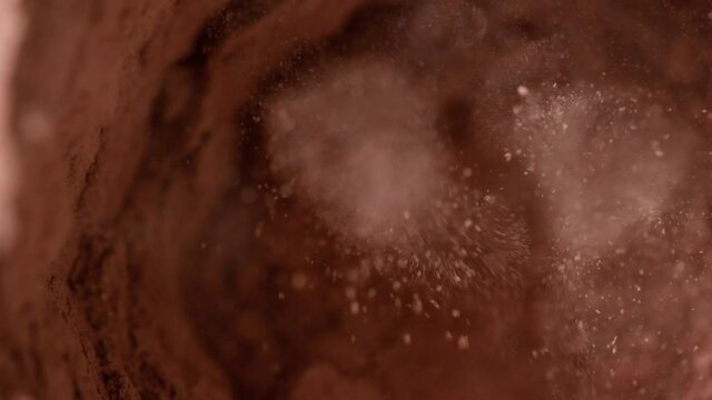 Cocoa powder in a blender. Real gold dust flies in the air. Gold dust is mixed in a blender. Natural cosmetic. close-up 