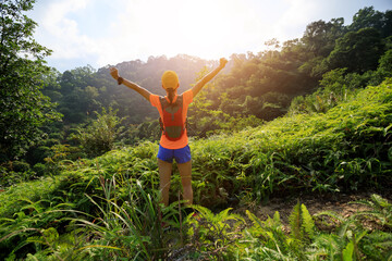 Freedom woman cheering in tropical forest