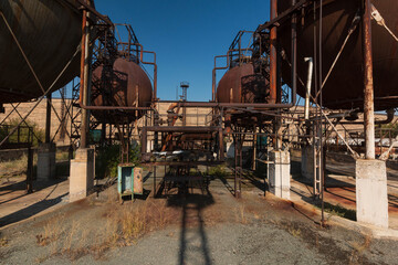 abandoned factory with rusty cisterns