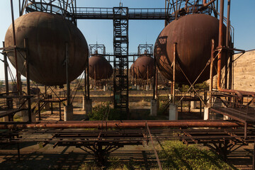 abandoned factory with rusty cisterns