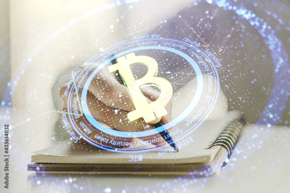 Poster double exposure of creative bitcoin symbol hologram with man hand writing in notepad on background. 