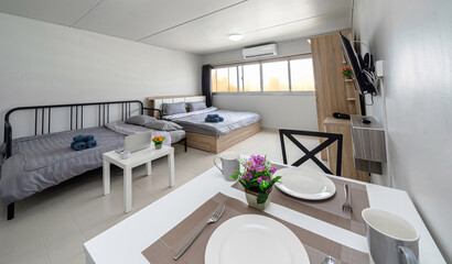 Luxury Interior living room with sofa bed and bed queen size, Dining table,air conditioner, and furniture, Studio room type of condominium or apartment, service apartment and Accommodations Concept