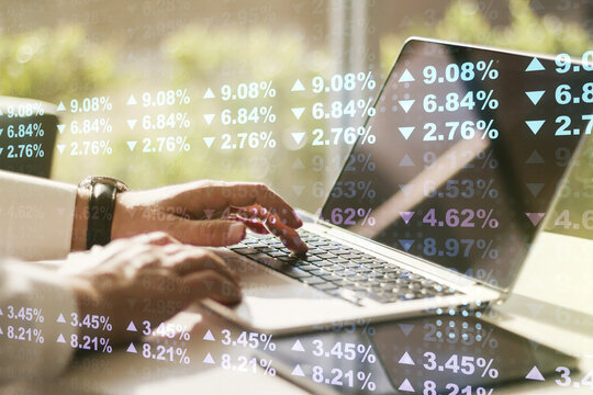 Double exposure of abstract creative statistics data hologram with hands typing on laptop on background, analytics and forecasting concept