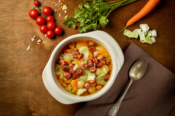 Homemade Frankfurter Sausage in a white soup plate isolated on wooden background.