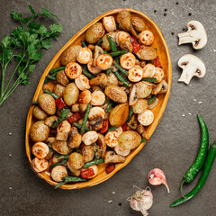 Side dish of baked vegetables asparagus bean, pepper, mushrooms and sausage, vertical orientation.