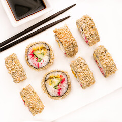 Raw fresh sushi roll with soy sauce in white plate, Japanese food style