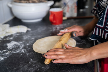 Black Muslim woman frying chapati
