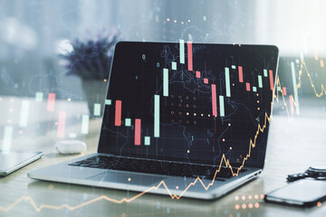 Abstract creative financial graph with world map on modern laptop background, forex and investment concept. Multiexposure