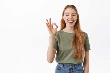 Very well. Laughing happy candid girl, showing okay OK sign and nod in approval, agree, like and...