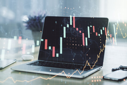 Abstract creative financial graph with world map on modern laptop background, forex and investment concept. Multiexposure