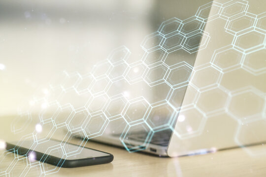 Creative concept of wireless technology with hexagon hologram on modern laptop background. Big data and database concept. Multiexposure