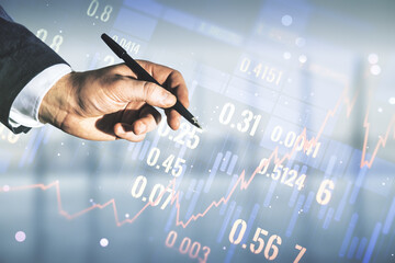Double exposure of man hand with pen working with abstract creative financial chart hologram on blurred office background, research and strategy concept