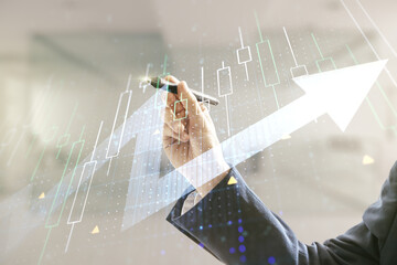 Multi exposure of man hand with pen working with abstract financial diagram and upward arrow on blurred office background, rise and breakthrough concept