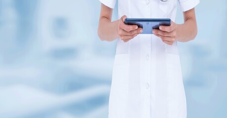 Midsection of doctor using digital tablet over blue background, healthcare and technology concepts