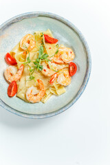 bright juicy seafood with spaghetti in a plate on a light background, mussels, shrimps, black pasta, close-up, restaurant serving