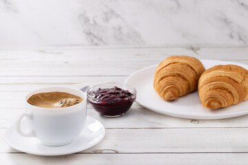 cup of coffee and croissants with jam