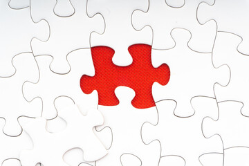 Red jigsaw puzzle pieces on red background. Copy space and business concept