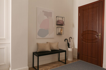 Modern hallway interior with stylish bench and decor