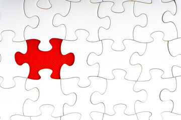 Fototapeta premium Red jigsaw puzzle pieces on red background. Copy space and business concept