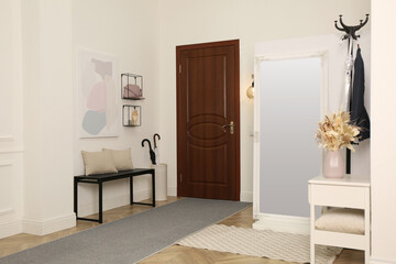 Obraz na płótnie Canvas Modern hallway interior with stylish furniture and mirror