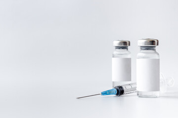 Vaccination with Covid vaccine in bottles with syringe