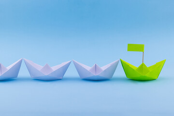 Red Paper Boat Leading A Fleet Of Small White Boats - Leader ship Concept