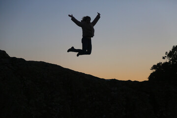 silhouettes of people in the mountain with sunrise sky background