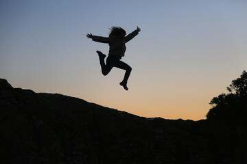 silhouettes of people in the mountain with sunrise sky background