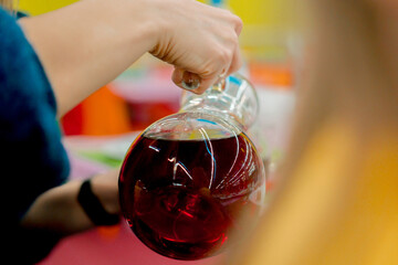 Woman hand poring red drink from the decanter. Drinks. Juice. Holiday. Restaurant. Cafe. Pour