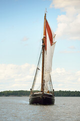 An elegant two-masted gaff schooner (training tall ship) sailing in Mälaren lake, Sweden. Travel, history, traditions, transportation, sailing, sport, cruise, regatta, teamwork. Panoramic view