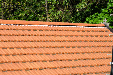 Building: detail of the roof, with a multi-pitched roof, in tiles called 