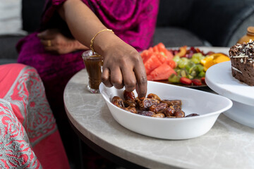 Black Muslim woman eating dates 