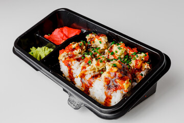 Japanese food: maki and nigiri sushi set. Sushi rolls with rice, fish salmon, smoked eel, avocado, cream cheese, soy Teriyaki sauce, sesame. Chopsticks, wasabi and Pickled Ginger.